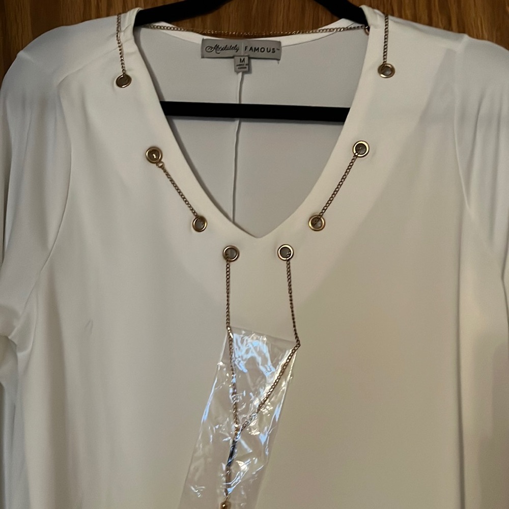 Off white cream blouse, with bronz-y gold colored accent chain. BNWT